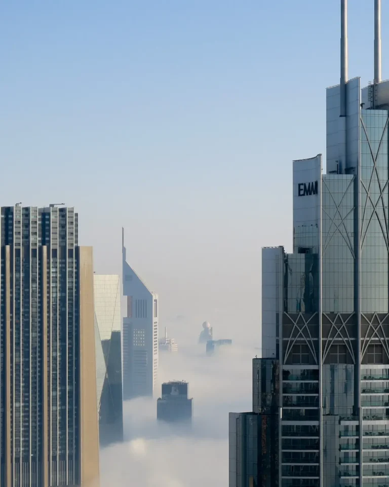 Dubai skyscrappers within a misty and cloudy atmosphere