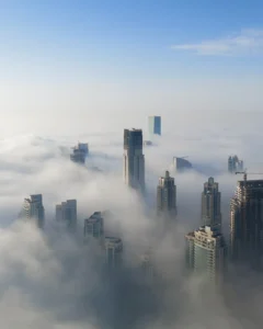 Dubai skyscrappers within a misty and cloudy atmosphere