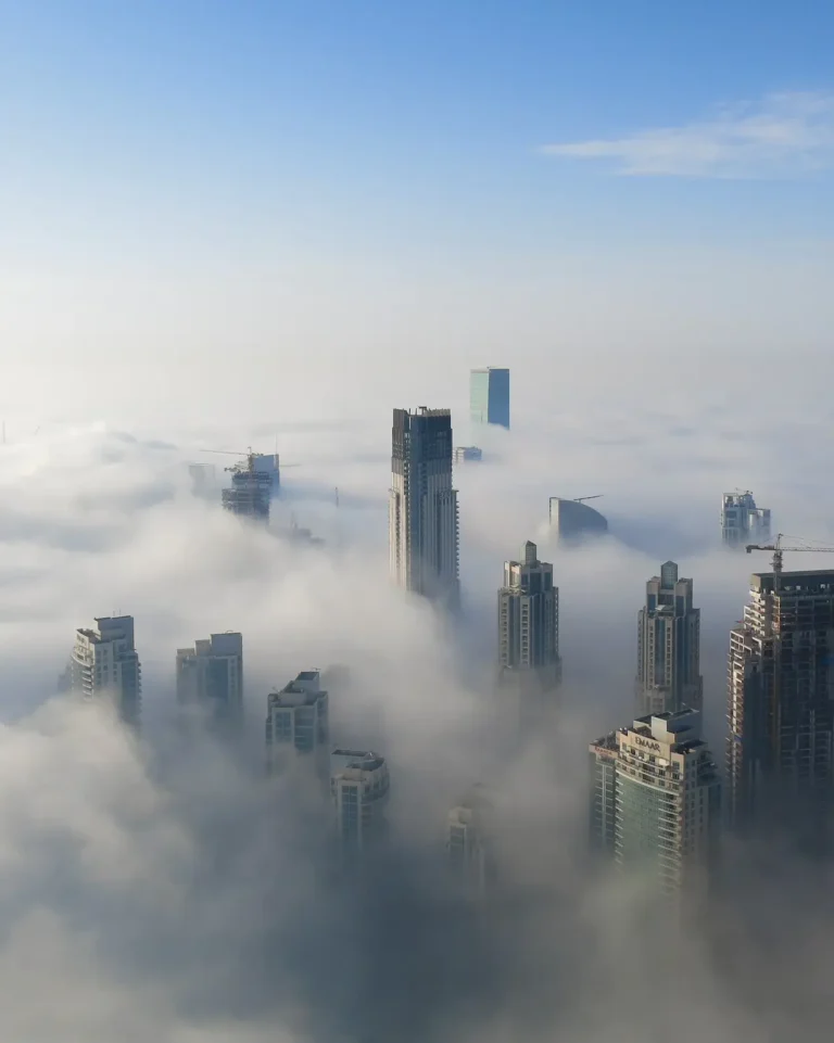 Dubai skyscrappers within a misty and cloudy atmosphere