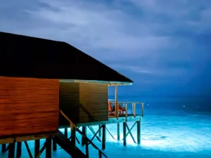 Wooden bangalo in a neverending blue sea landscape