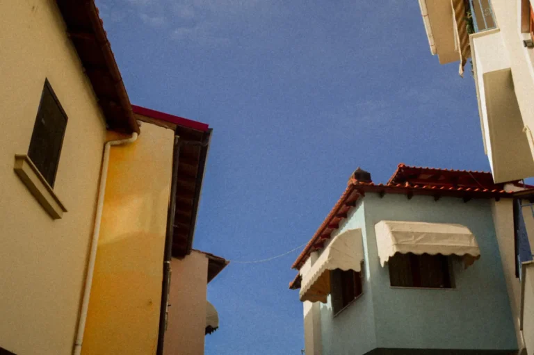 Yellow and blue houses that create geometry in the sky